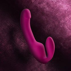 Pink plastic hook on a textured purple background
